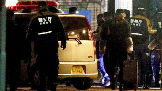 A car is inspected by police after it injured several pedestrians on Takeshita Street in Tokyo, early on new year's day.