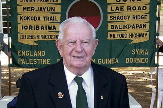 Ken Walters with the 2/33 Battalion banner.