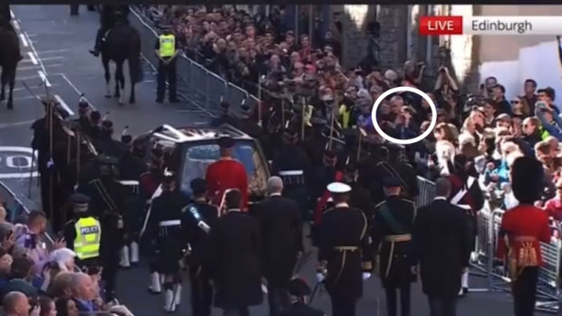 A heckler shouts at Prince Andrew as the Queen’s coffin is taken up the Royal Mile in Edinburgh.