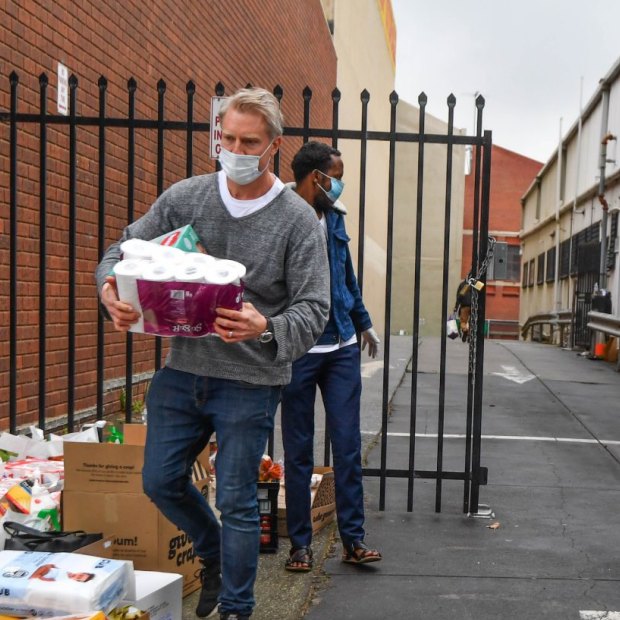 Deputy lord mayor Arron Wood helping collect donations at a North Melbourne mosque during the hard lockdown of high-rise housing towers in July.