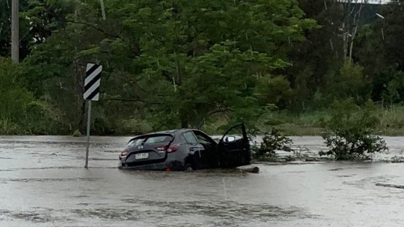 Flooding cuts roads, swamps cars as torrential rain tops up dams - Brisbane Times