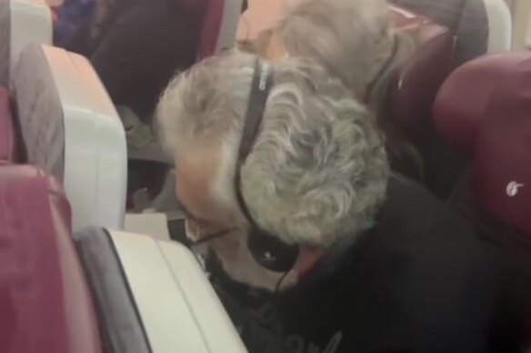 Perry Kouroumblis on a flight from Rome as he returns to Australia.