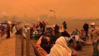 Locals and residents seek refuge on the Mallacoota wharf on New Years Eve.