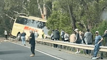 Footage shared to Facebook shows the bus teetering off an embankment after it crashed through traffic barriers on the highway.