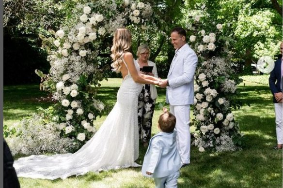 Rob Deutsch and Nicole Perso exchanging vows at their wedding ceremony last December.