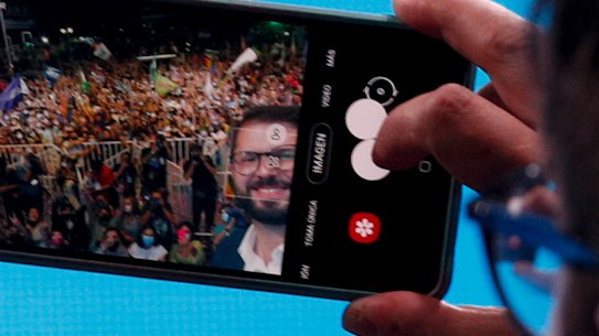 Chile’s President elect Gabriel Boric, of the “I approve Dignity” coalition, takes a selfie with his supporters after his victory in the presidential run-off election in Santiago.