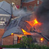Firefighting cranes were called in as a Brisbane fire spread to multiple buildings at peak hour on Wednesday.