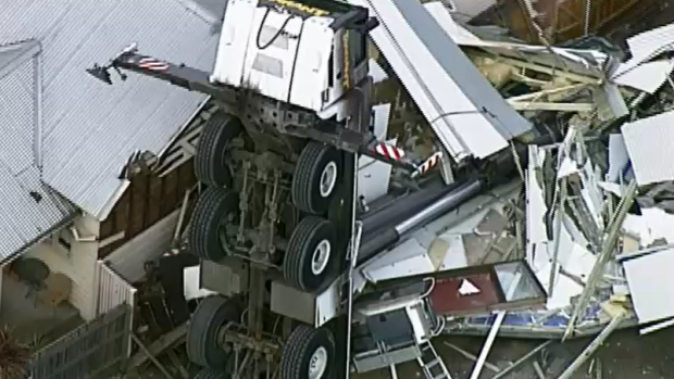 A crane has collapsed onto a house in Yarraville. 
