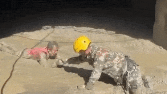 Soldiers rescue survivors at the hydropower plant.