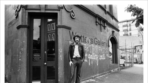 Frank Watters outside his Riley St gallery, East Sydney in 1979, graffitti reads 'posters for factory walls not gallery walls' Watters Gallery at 109 Riley Street, Darlinghurst, Sydney