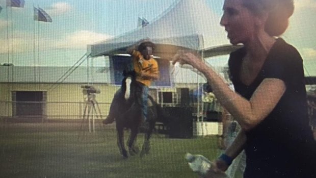 A protester's video of a man riding a horse in Clermont showground before a woman was hit. Police have laid charges.