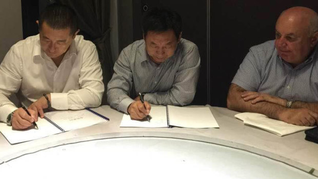 Wensheng Liu, Yuqing Liu and Vince Badalati at the signing ceremony in Sydney's Chinatown.