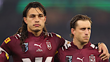 Tino Fa'asuamaleaui and Cameron Munster of the Maroons line up for the national anthem.