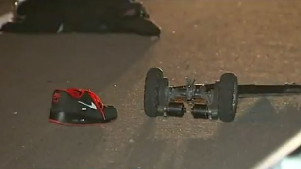 A man is fighting for his life after he collided with a car while skateboarding on the Gold Coast.