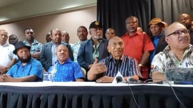 PNG Prime Minister Peter O'Neill (right) announcing he would step aside on Sunday. Sir Julius Chan (centre right) was his nominated successor.
