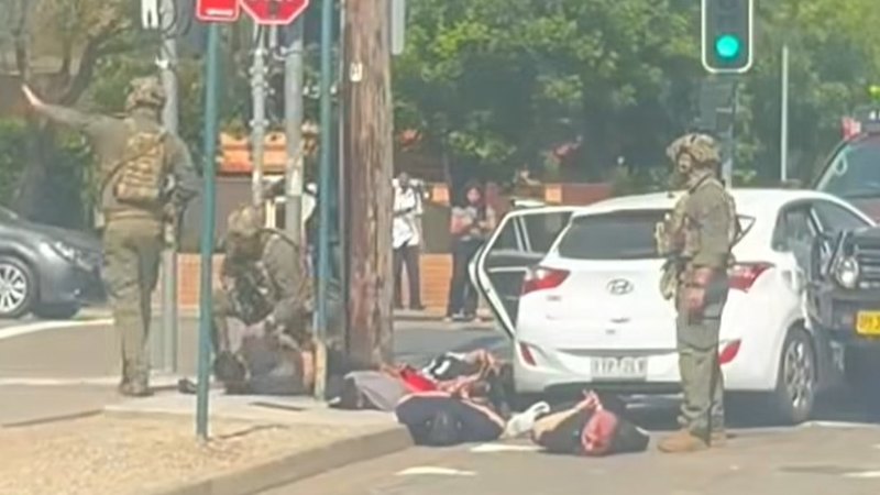 Heavily armed tactical police arrest men on way to Bondi