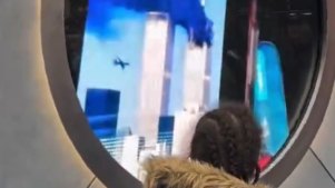 A New Yorker looks on as a person in Dublin shows an image of 9/11 to the portal camera.