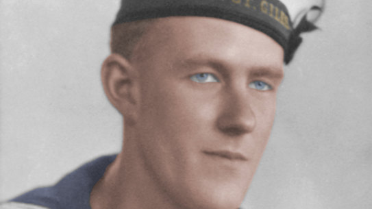 A colourised studio portrait of S/4449 Ordinary Seaman Thomas Welsby Clark. 