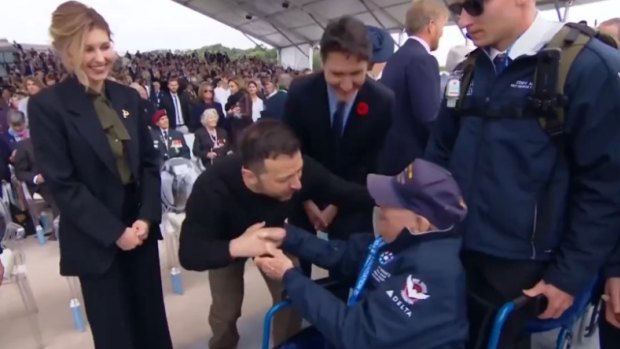 Ukrainian President Volodymyr Zelensky embraces a veteran of D-Day at the 80th anniversary of the invasion, as his wife Olena and Canadian PM Justin Trudeau look on.