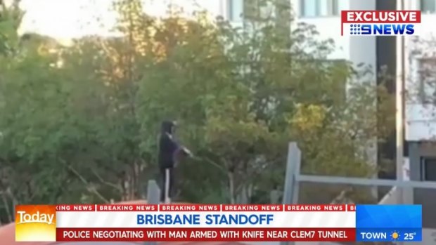 Police negotiated with the armed man, who was on top of the Clem7 tunnel entrance in Kangaroo Point.