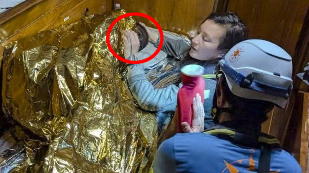 Rescuers attend to the 11-year-old girl from Sierra Leone (circled) who was found floating in the Mediterranean Sea.