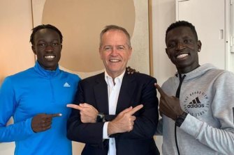 Bol with flatmate and fellow runner Joseph Deng and Bill Shorten, who helped the pair find a rental flat.