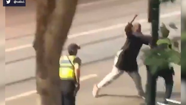 Hassan Khalif Shire Ali lunges at police during the Bourke Street attack on Friday.