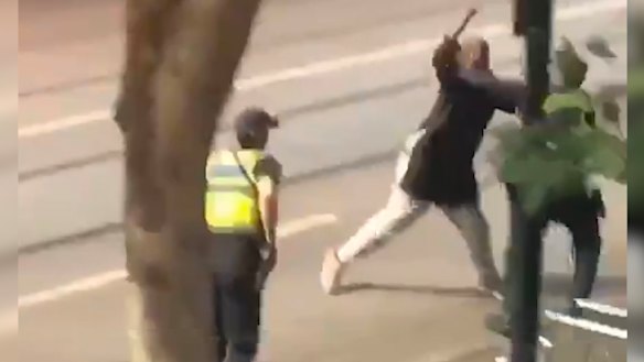 The man lashes out at police before being shot.