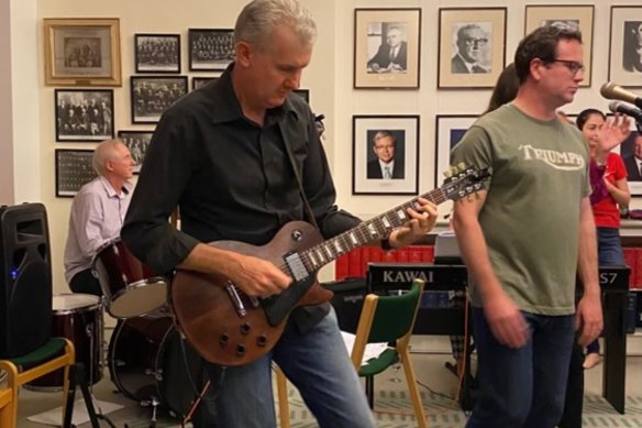 Tony Burke on guitar and Veterans’ Affairs Minister Matt Keogh singing in the Labor Party caucus room in the band Left Right Out.