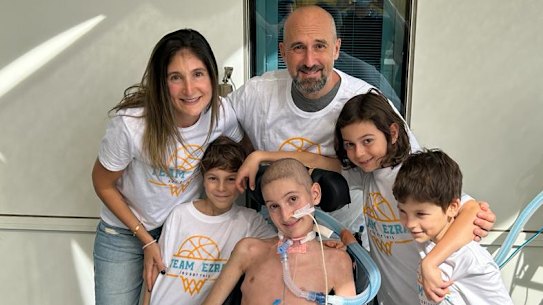 Ezra in hospital surrounded by his family (from left) mum Natasha, brother Alon, dad Dean and brothers Levi and Eden.