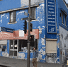 An artist’s impression of a proposed 24 hour McDonald’s restaurant in Redfern and the site as it stands.