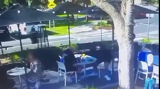 A still from CCTV footage shows a killer dressed in black approaching Gavin Preston before he is shot outside a cafe.