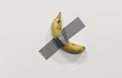 Gallery owner Emmanuel Perrotin poses next to Maurizio Cattlelan's Comedian at the Art Basel exhibition in Miami Beach, Florida. The work sold for $US120,000 – and also eaten.