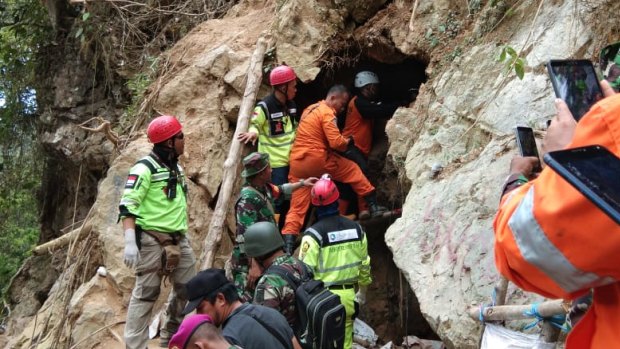 Rescue workers scramble to reach survivors still inside the collapsed illegal gold mine.