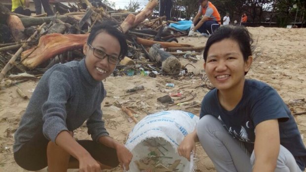 Bali Wise Program Co-ordinator Fena Evans (left) and a student take part in a beach clean-up run by the ROLE Foundation in Bali.
