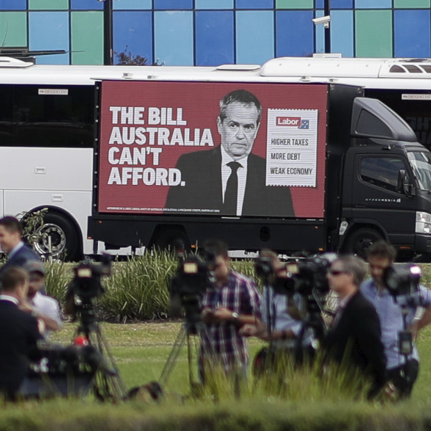 A truck drives past media setting up for a doorstop interview during Bill Shorten's visit to Casey Hospital.
