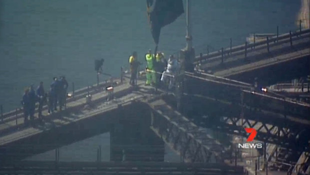 The Invictus Games flag is mounted and raised on the Sydney Harbour Bridge.