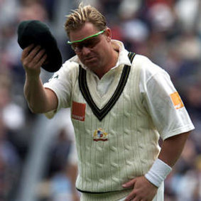 Shane Warne in his playing days with with baggy green in hand.