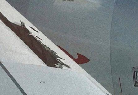 A photo posted on Instagram by Lynn Gilmartin showing a hole in the wing of a Qantas plane.
