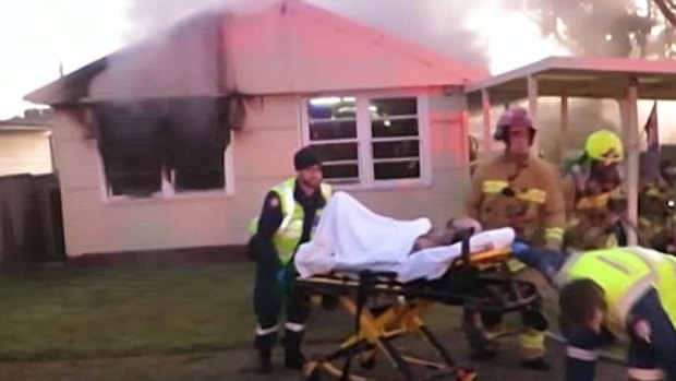 A critically injured man is rescued from a house fire in Seven Hills.