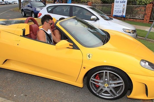Bernard Tomic driving his yellow Ferrari back in 2014.