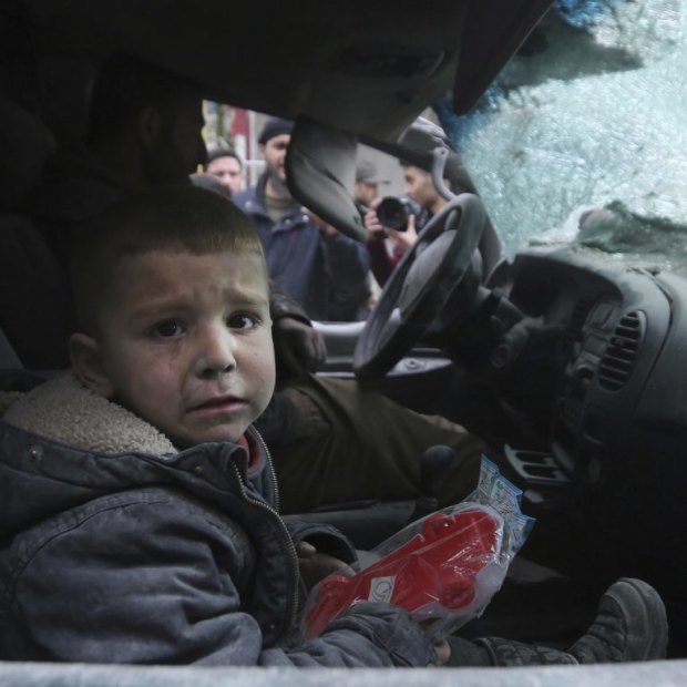 A boy in a damaged car after government air strikes in the town of Ariha, in Idlib province last month.  