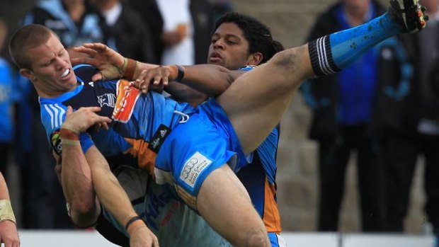 Steve Michaels gets tackled while he was playing in the NRL with the Gold Coast Titans.