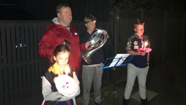 Rob Feeney's young family play the last post in Malvern on Saturday morning.