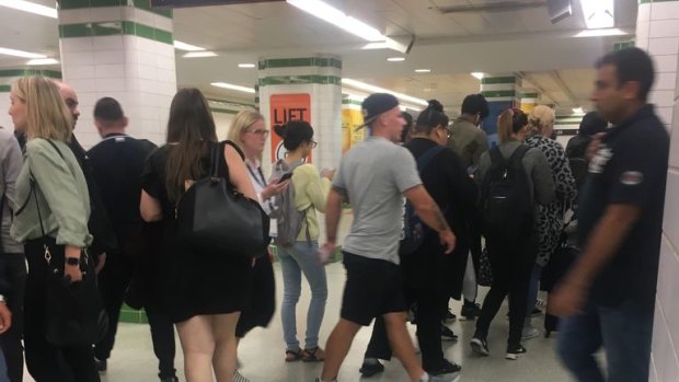 Commuters spill out onto the concourse below the platforms at Central station as trains stop on Friday night.