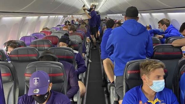 West Coast and Fremantle share a chartered flight on Tuesday, with some not wearing masks correctly.