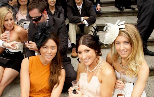 Punters enjoy the atmosphere in the crowd on Melbourne Cup Day. No social distancing.