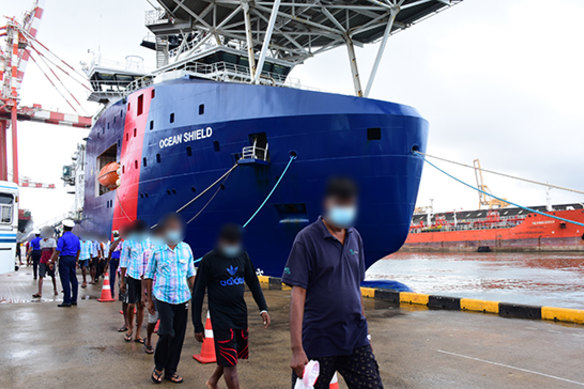 Some of the Sri Lankan men leave the Ocean Shield in Colombo on Friday.