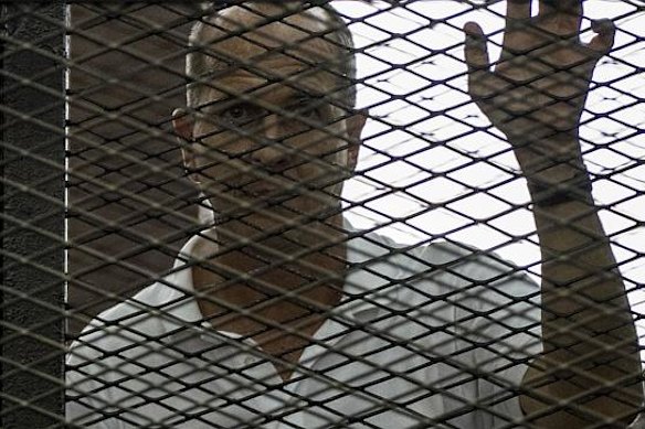 Greste inside the defendants’ cage during his trial. 
