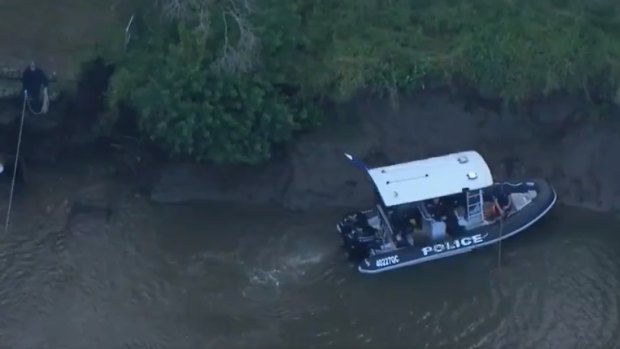 The scene on the Albert River in Eagleby on Friday after police found a missing man’s body. 